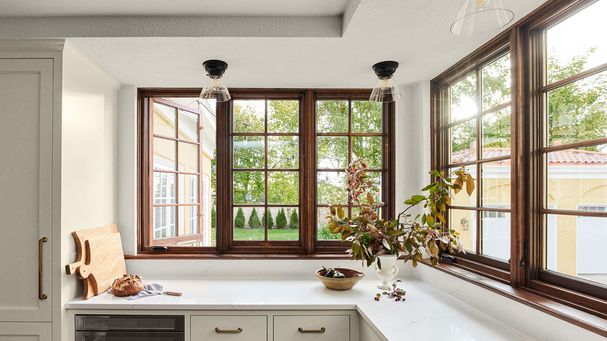 marvin_ultimate_wood_casement Wood casement window opened outward above a kitchen counter.